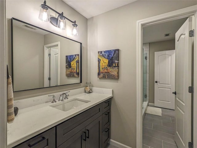 bathroom with tile patterned floors, vanity, and a shower