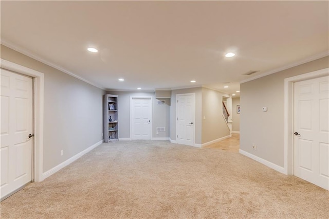 basement with light colored carpet and ornamental molding