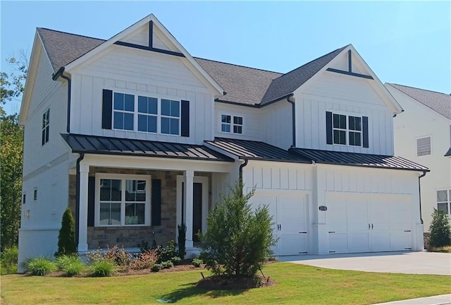 modern farmhouse style home with a garage, a front yard, and covered porch