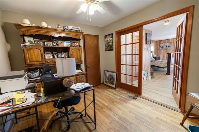 office with light hardwood / wood-style flooring, french doors, and ceiling fan