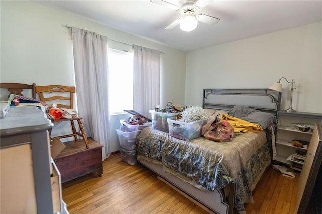 bedroom with ceiling fan and light hardwood / wood-style flooring