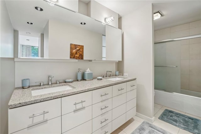 full bathroom with tile patterned floors, vanity, toilet, and combined bath / shower with glass door