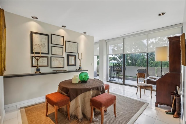 dining room with floor to ceiling windows and light tile patterned flooring