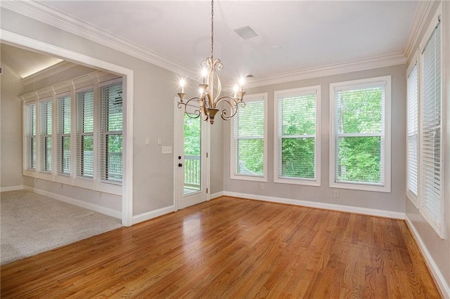 unfurnished room featuring a chandelier, baseboards, plenty of natural light, ornamental molding, and light wood-style flooring