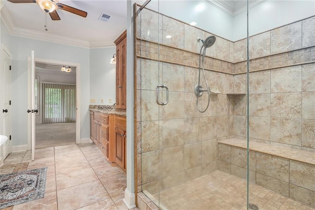 bathroom featuring a ceiling fan, a shower stall, ornamental molding, vanity, and baseboards