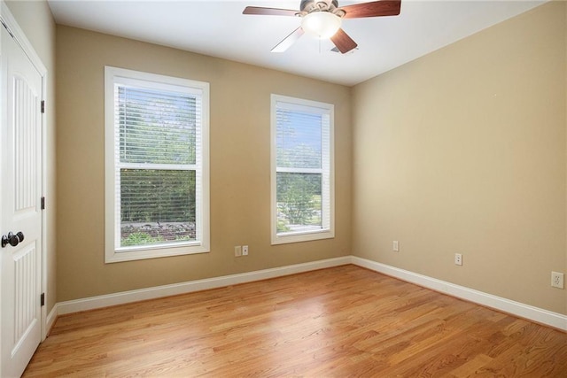 unfurnished room with light wood-style flooring, baseboards, and a ceiling fan