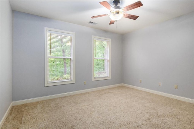 unfurnished room featuring carpet floors, baseboards, and a ceiling fan