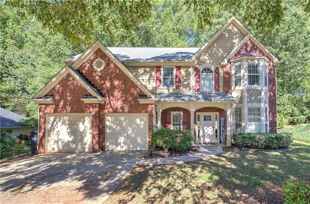 view of front of property with a garage, a front yard, and covered porch