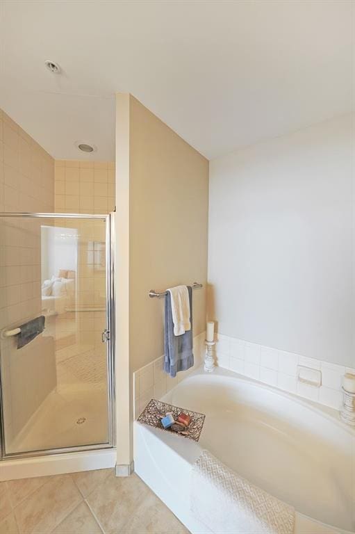 bathroom featuring plus walk in shower and tile patterned floors