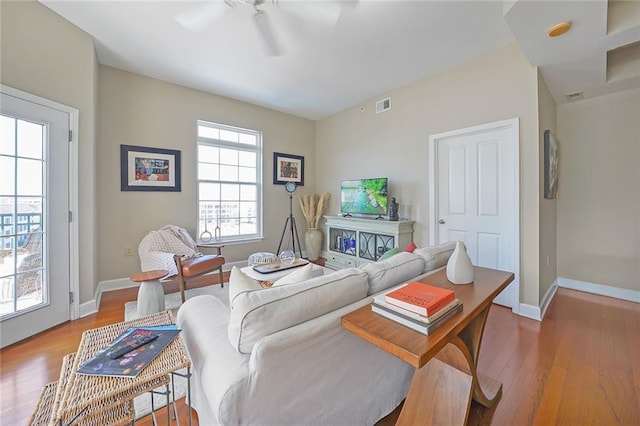 living room with hardwood / wood-style flooring and ceiling fan