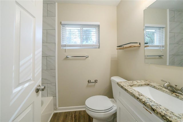 full bathroom featuring washtub / shower combination, vanity, toilet, and hardwood / wood-style floors