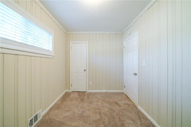 carpeted empty room with crown molding