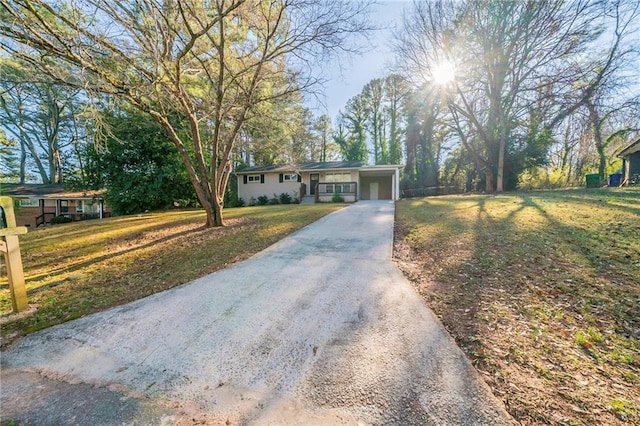 ranch-style home with a front lawn and a carport