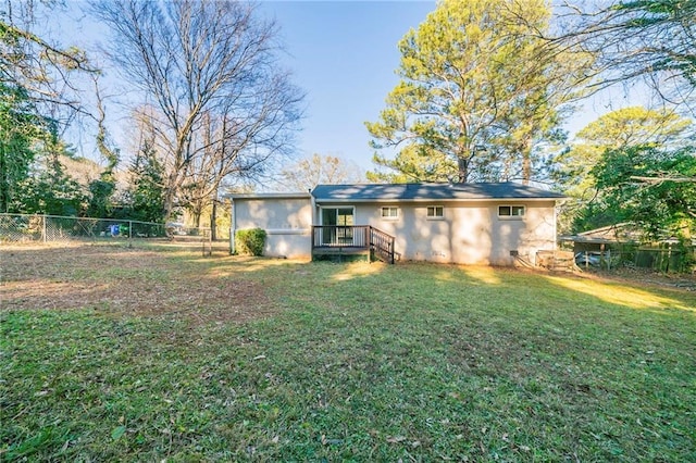 rear view of property with a lawn