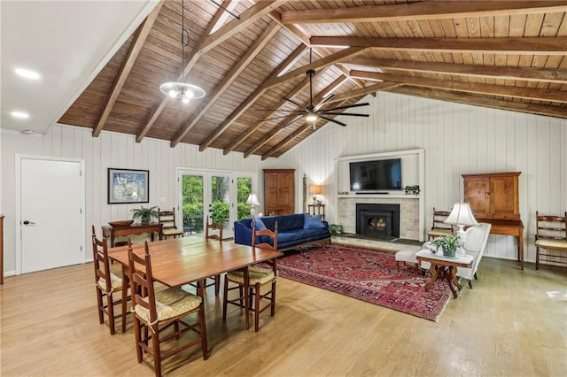 3311 Stillhouse Rd SE, Atlanta, GA 30339 - dining space featuring wood finished floors, a fireplace with raised hearth, wooden ceiling, ceiling fan, and wood walls