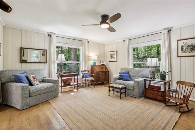 3311 Stillhouse Rd SE, Atlanta, GA 30339 - living area featuring wood finished floors, ceiling fan, plenty of natural light, ornamental molding, and a decorative wall