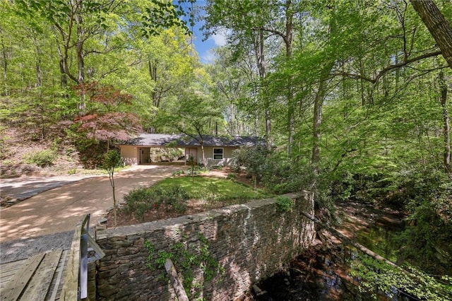 3311 Stillhouse Rd SE, Atlanta, GA 30339 - view of front of house featuring driveway, a forest view, and a carport