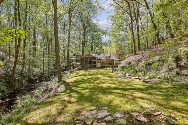 3311 Stillhouse Rd SE, Atlanta, GA 30339 - view of green lawn with a view of trees and a sunroom
