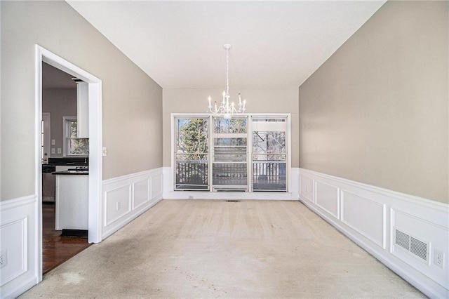 unfurnished dining area with an inviting chandelier