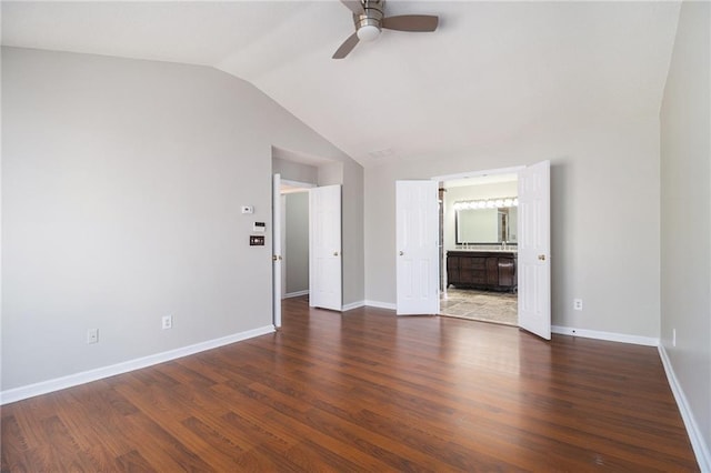 empty room featuring vaulted ceiling, ceiling fan, and dark hardwood / wood-style flooring