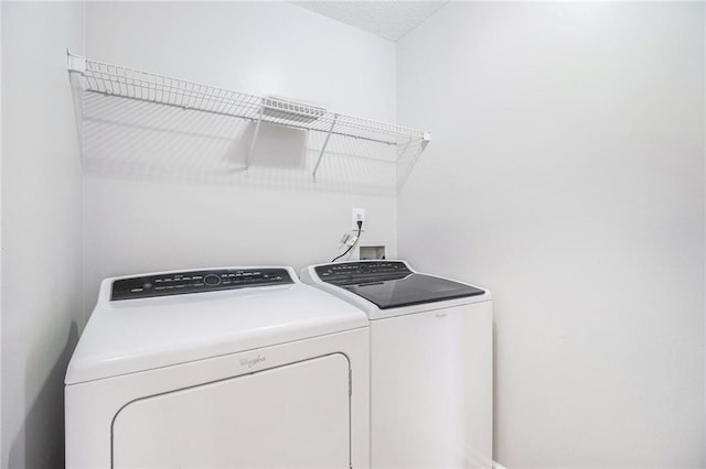 washroom featuring independent washer and dryer