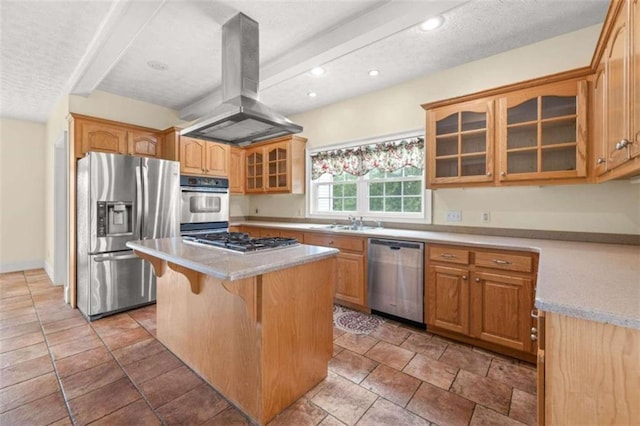 kitchen featuring appliances with stainless steel finishes, island range hood, a kitchen island, and light tile patterned floors