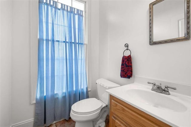 bathroom with toilet and vanity