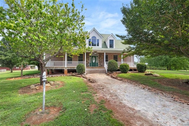 cape cod-style house featuring a front lawn and covered porch