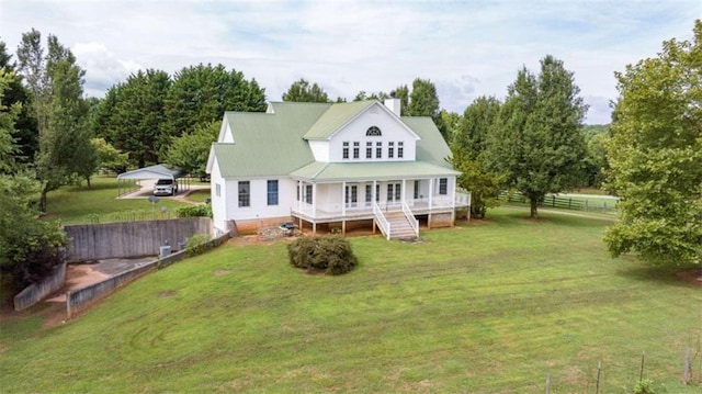 rear view of house featuring a lawn