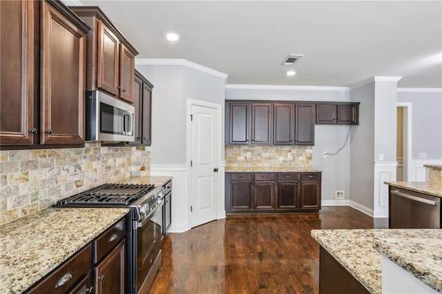 kitchen featuring stainless steel appliances, dark brown cabinetry, light stone counters, dark hardwood / wood-style flooring, and ornamental molding