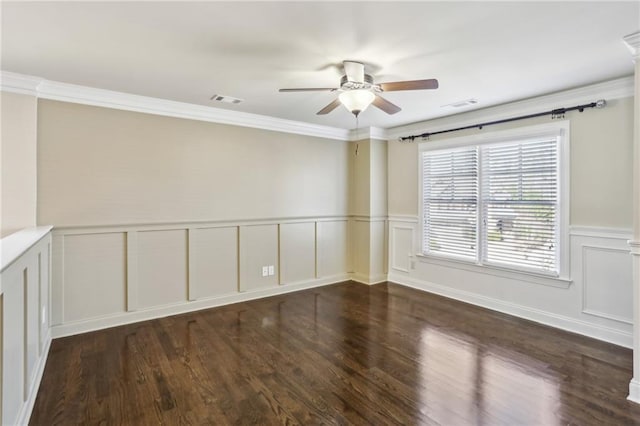 spare room featuring ceiling fan, dark wood-type flooring, and ornamental molding