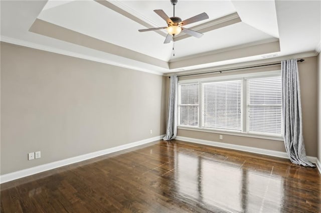 unfurnished room featuring ceiling fan, crown molding, a raised ceiling, and dark hardwood / wood-style floors