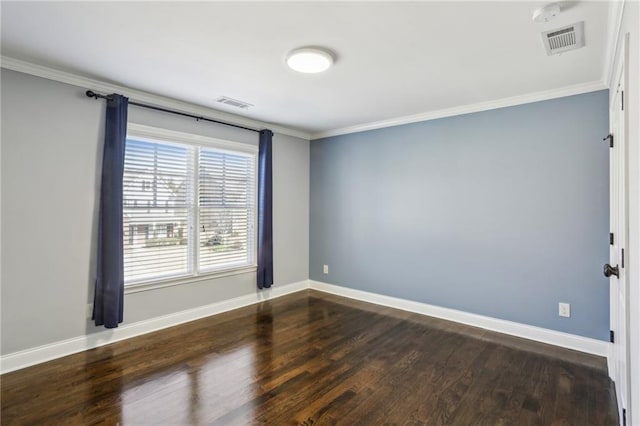 spare room featuring crown molding and dark hardwood / wood-style flooring