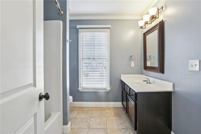 bathroom with a bath, tile patterned flooring, ornamental molding, toilet, and vanity