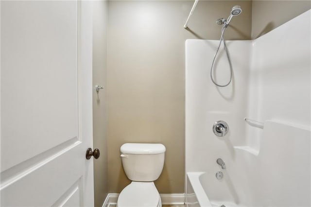 bathroom with washtub / shower combination and toilet