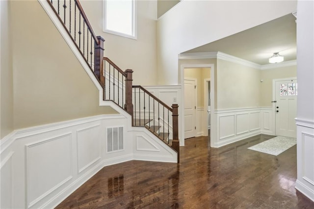 entryway featuring dark hardwood / wood-style flooring and crown molding