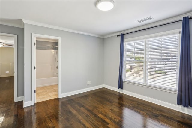 unfurnished bedroom with ornamental molding and dark hardwood / wood-style flooring