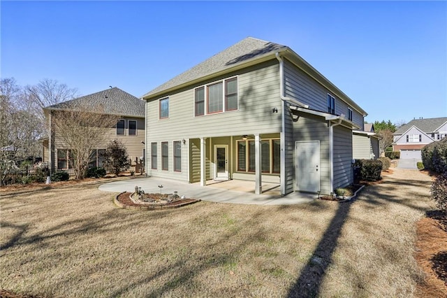 rear view of property featuring a patio area and a lawn