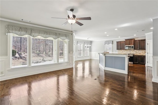 interior space with ceiling fan with notable chandelier, crown molding, and dark hardwood / wood-style floors