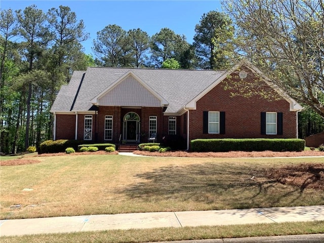 single story home featuring a front lawn