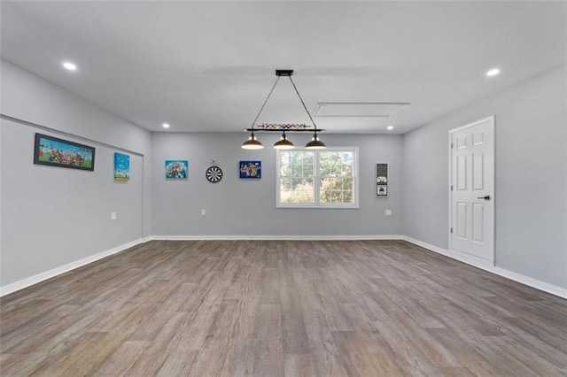 spare room featuring wood-type flooring