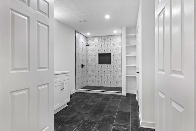 bathroom with tiled shower