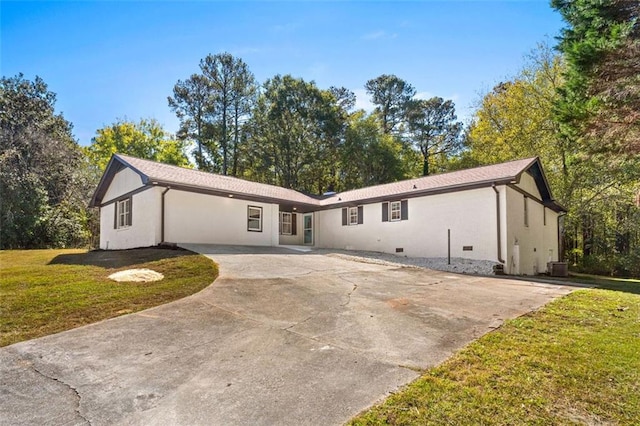 view of front of property with a front yard and central AC unit