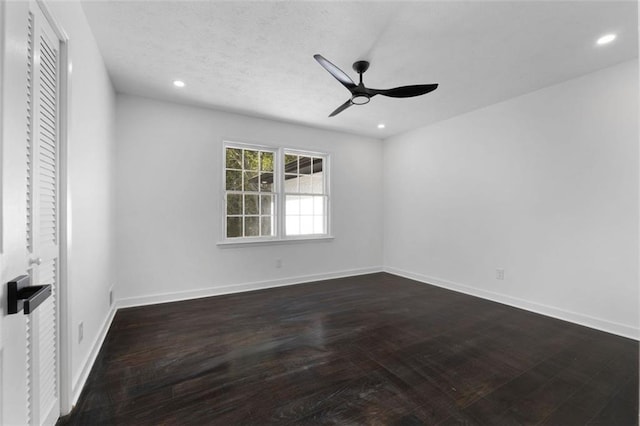 empty room featuring ceiling fan and dark wood-type flooring