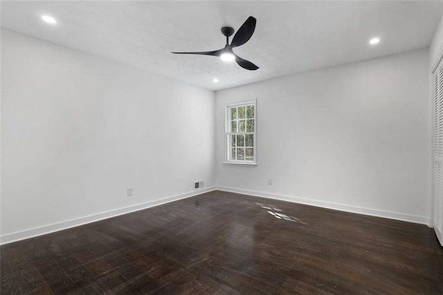 unfurnished room featuring ceiling fan and dark hardwood / wood-style flooring