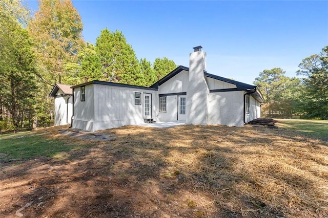 rear view of house with a yard