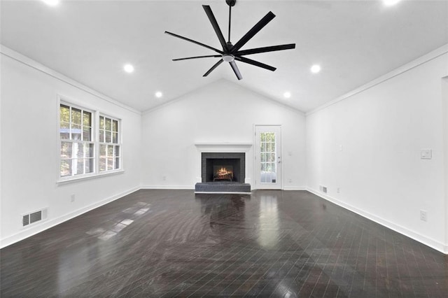 unfurnished living room with ornamental molding, a healthy amount of sunlight, lofted ceiling, and a brick fireplace