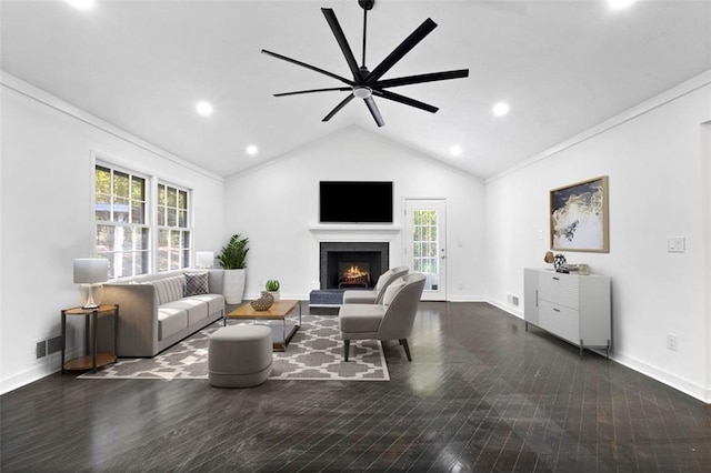 living room featuring ceiling fan, crown molding, dark wood-type flooring, and vaulted ceiling