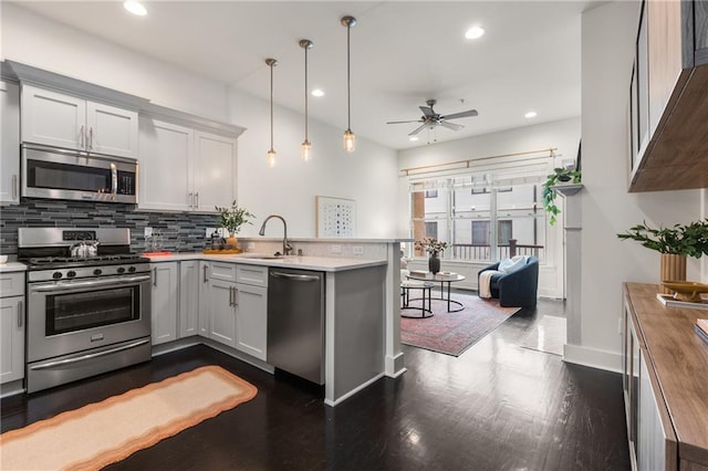 616 Angier Ave NE Unit 4, Atlanta, GA 30308 - kitchen with appliances with stainless steel finishes, a peninsula, dark wood finished floors, ceiling fan, and backsplash