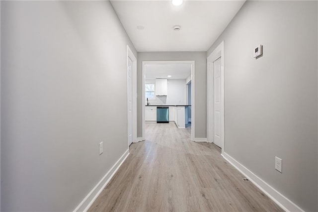 corridor with light wood-type flooring